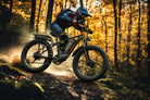 Two people riding DUOTTS S26 PRO Off-road Electric Bike in the forested mountains