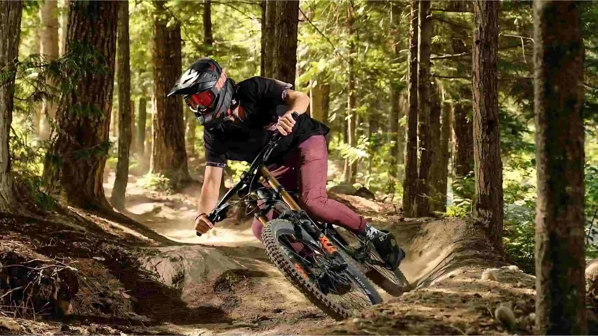 A man mountain biking in a forest