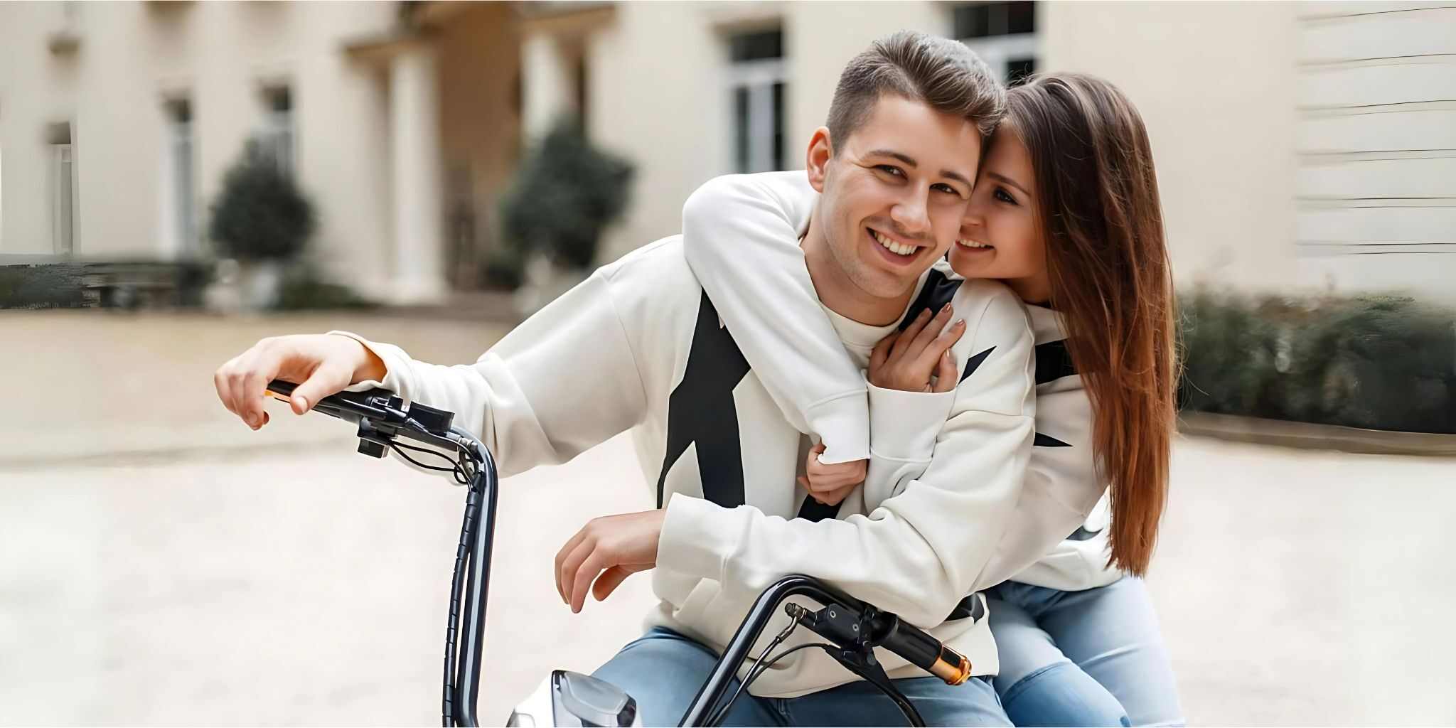 A beautiful young couple on an e-bike