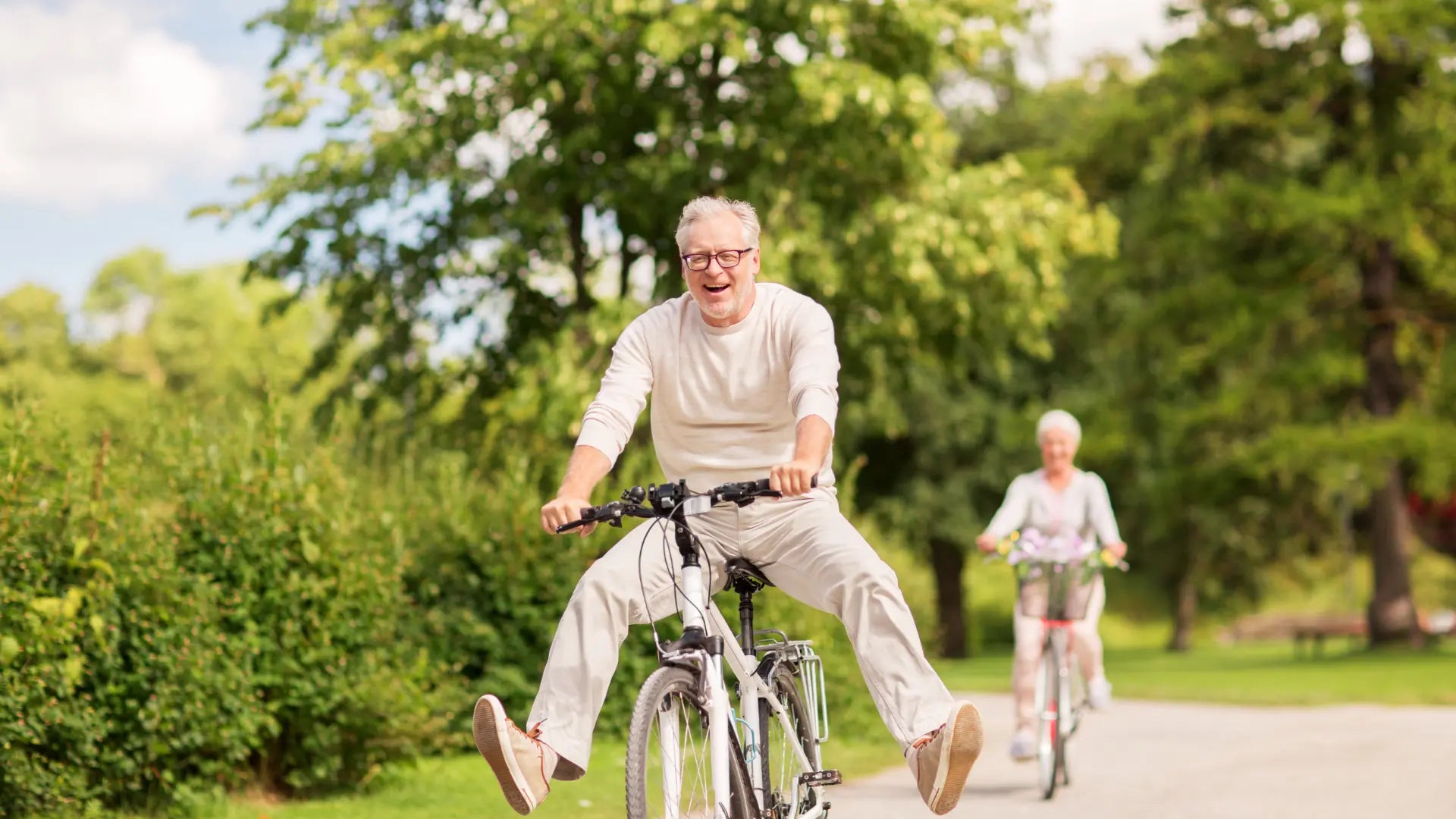 Happy senior couple biking
