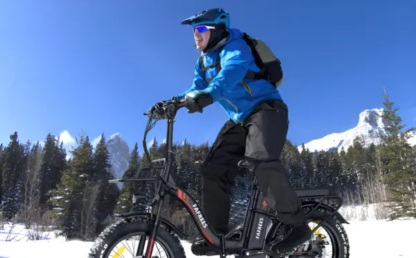 Man riding FAFREES electric bike n a snowy mountain path