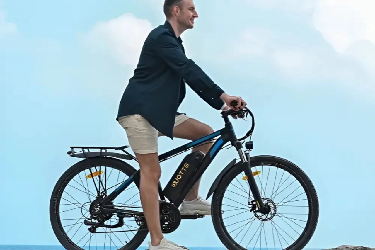 Man riding DUOTTS C29 PRO Electric Bike on a rocky beach
